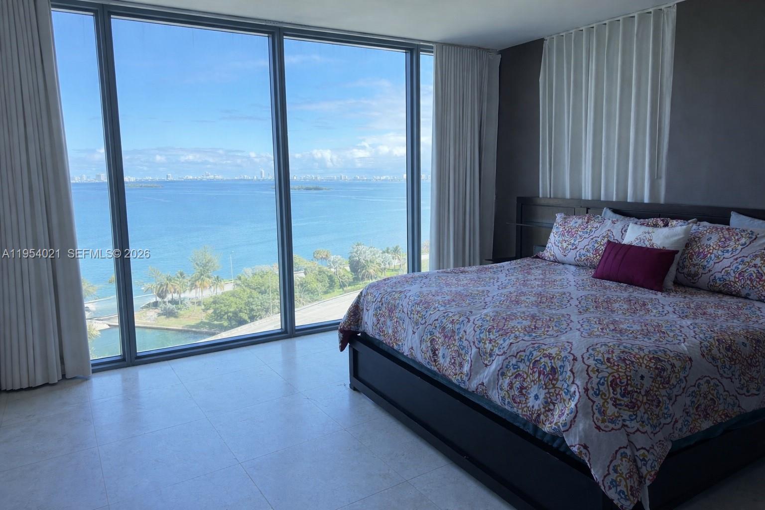 601 Northeast 36th Street, Unit 1112 Miami, FL 33137 - Photo 6 of 32 a bedroom with a large bed and a large window