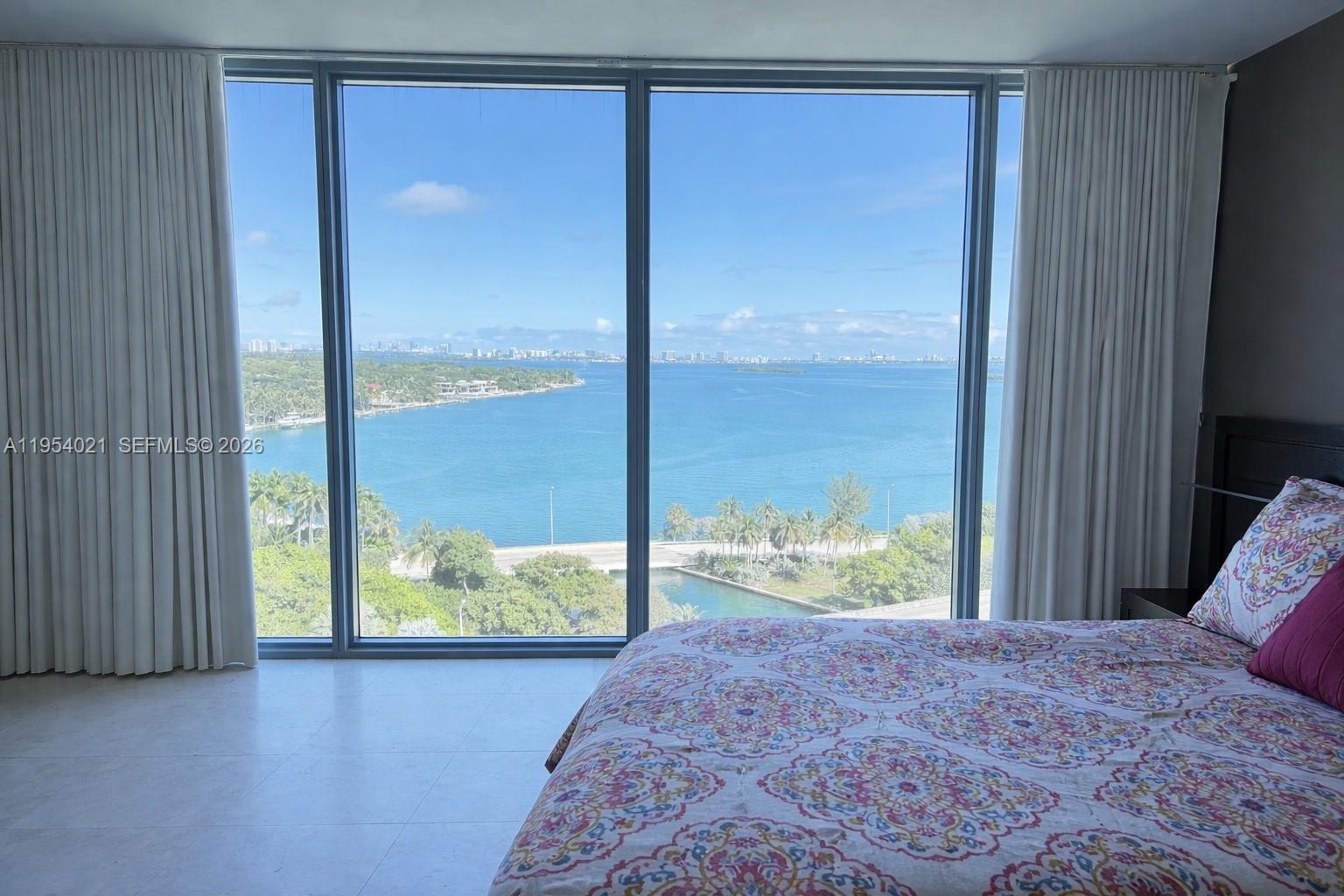 601 Northeast 36th Street, Unit 1112 Miami, FL 33137 - Photo 7 of 32 a bedroom with a bed and large window