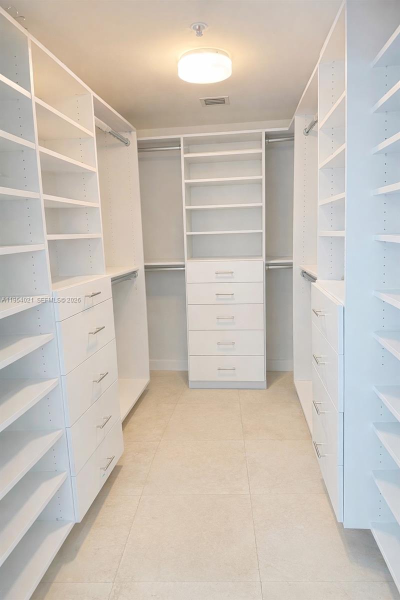 601 Northeast 36th Street, Unit 1112 Miami, FL 33137 - Photo 9 of 32 a view of walk in closet with empty racks