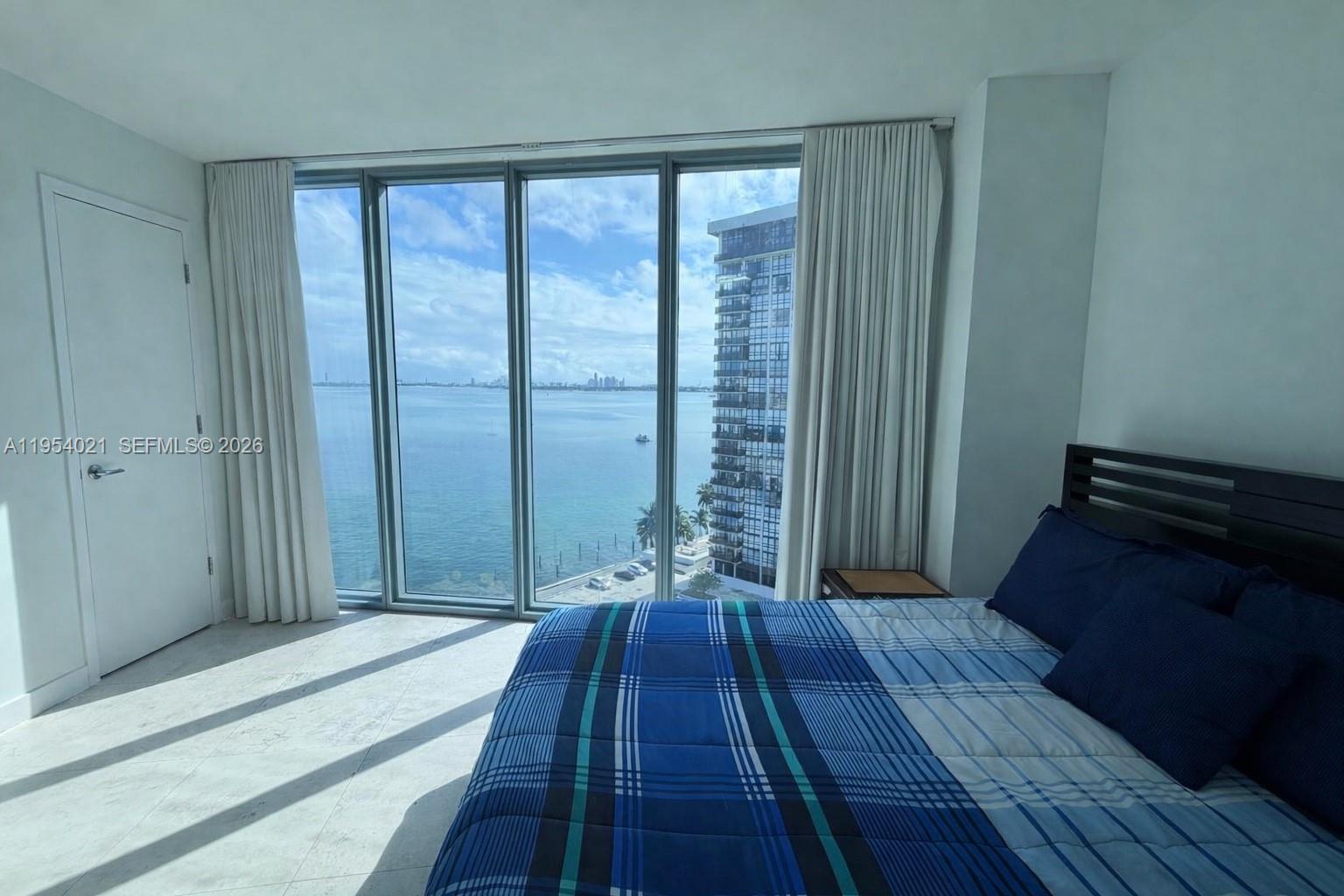 601 Northeast 36th Street, Unit 1112 Miami, FL 33137 - Photo 10 of 32 a view of a room with wooden floor and furniture