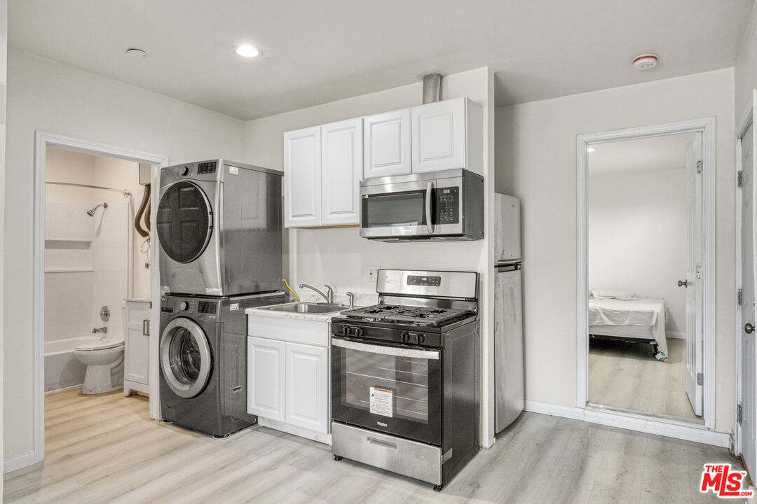 7703 Baird Avenue Reseda, CA 91335 - Photo 2 of 11 a utility room with sink dryer and washer
