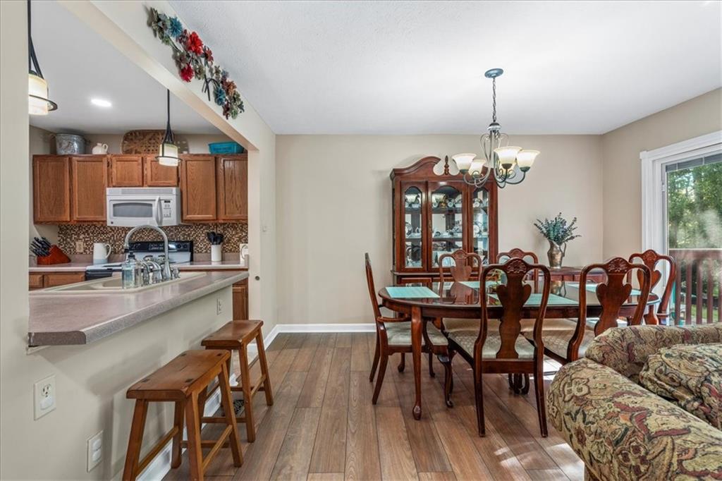 1489 Yorktown Drive Lawrence, PA 15055 - Photo 15 of 37 a view of a dining room and livingroom with furniture wooden floor a chandelier