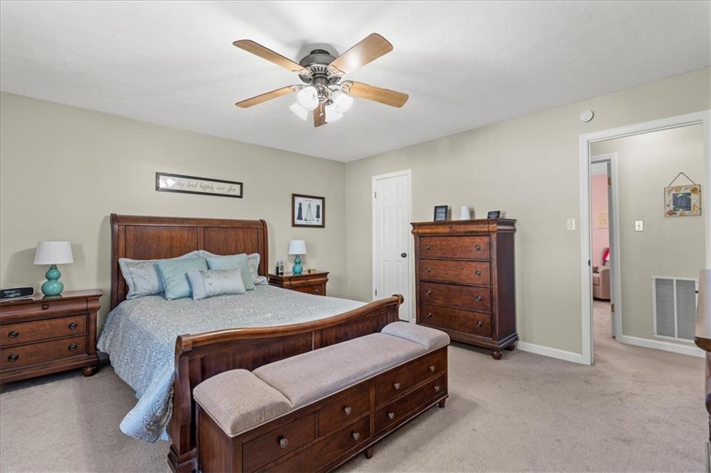 1489 Yorktown Drive Lawrence, PA 15055 - Photo 22 of 37 a bedroom with a bed and a chandelier