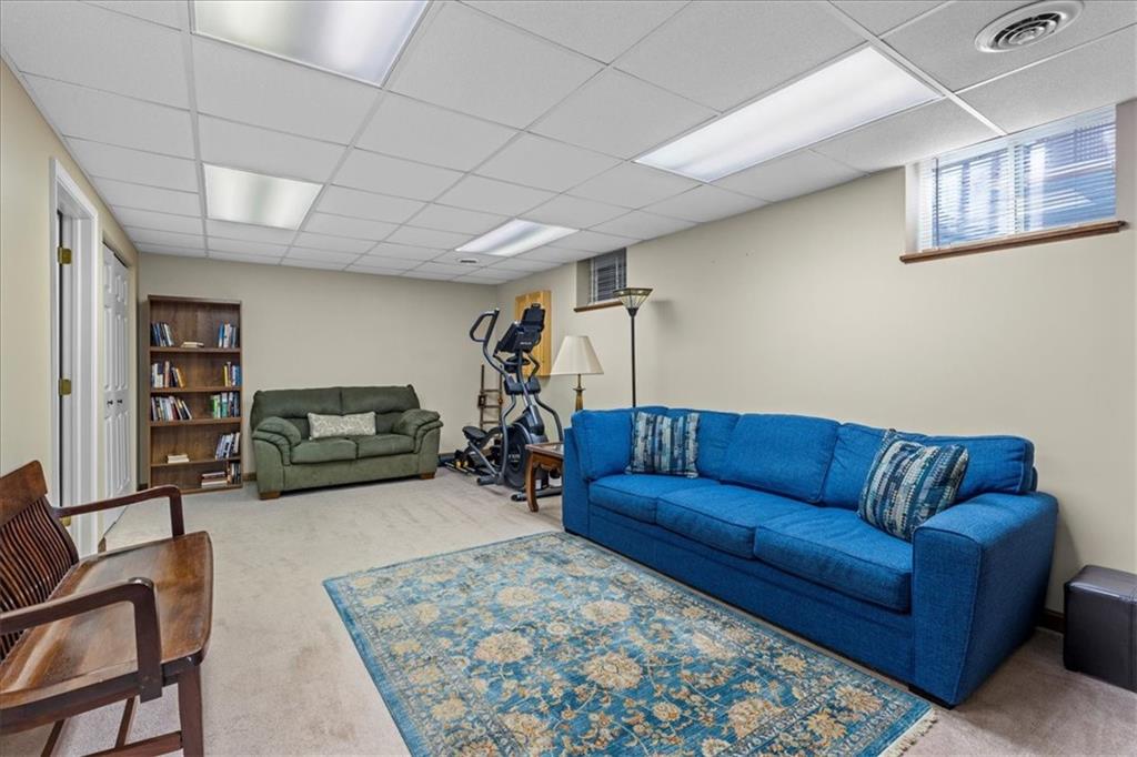 1489 Yorktown Drive Lawrence, PA 15055 - Photo 30 of 37 a living room with furniture ceiling fan and a rug