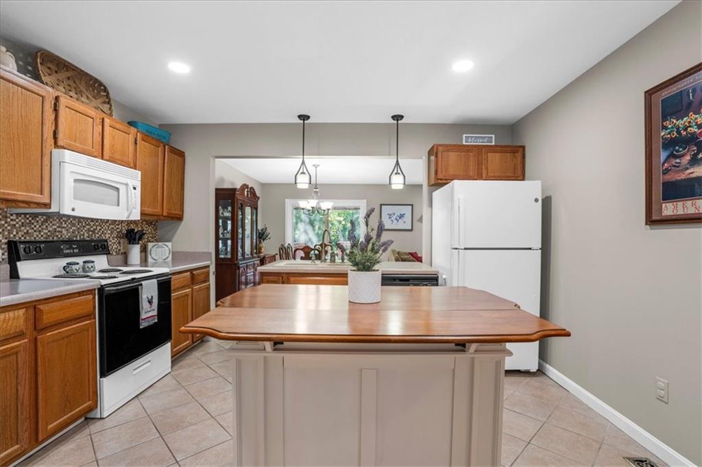 1489 Yorktown Drive Lawrence, PA 15055 - Photo 7 of 37 a kitchen with stainless steel appliances granite countertop a sink a stove and a refrigerator