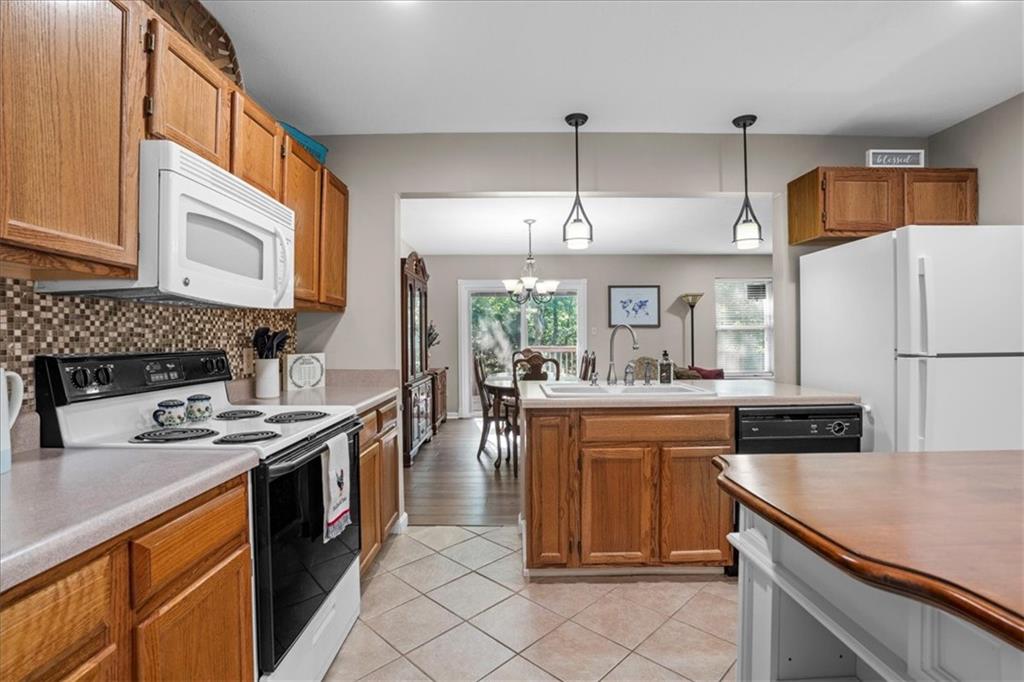 1489 Yorktown Drive Lawrence, PA 15055 - Photo 8 of 37 a kitchen with a stove a sink and a refrigerator
