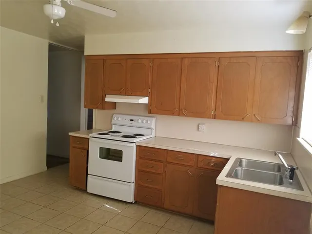 a kitchen with a stove and a sink
