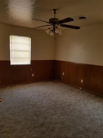 a view of an empty room and a window