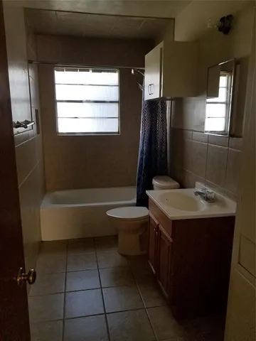 a bathroom with a sink a toilet and bathtub