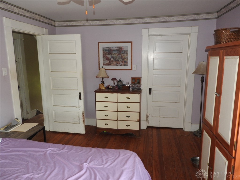2105 East Loy Road Piqua, OH 45356 - Photo 20 of 26 This spacious bedroom features classic hardwood floors and two elegant panel doors.
