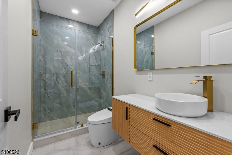 404 Washington Street Perth Amboy, NJ 08861 - Photo 14 of 45 a bathroom with a sink a toilet and shower