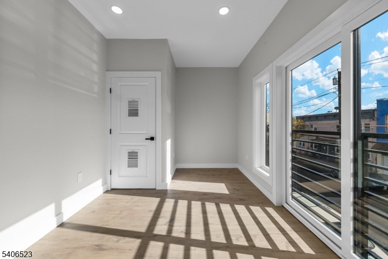 404 Washington Street Perth Amboy, NJ 08861 - Photo 22 of 45 wooden floor in an empty room with a window