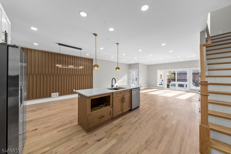 404 Washington Street Perth Amboy, NJ 08861 - Photo 24 of 45 a large kitchen with stainless steel appliances a large counter top a stove and a refrigerator