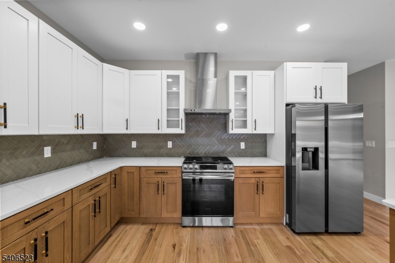 404 Washington Street Perth Amboy, NJ 08861 - Photo 30 of 45 a kitchen with a refrigerator a sink and wooden cabinets