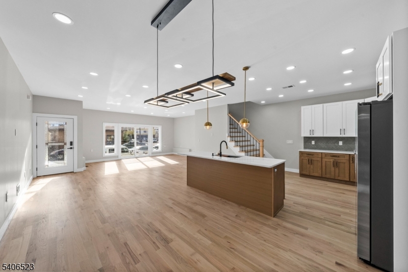 404 Washington Street Perth Amboy, NJ 08861 - Photo 32 of 45 a large kitchen with stainless steel appliances kitchen island a large counter top and a wooden floors