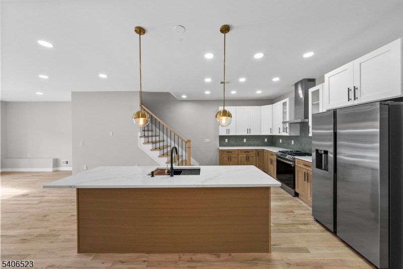 404 Washington Street Perth Amboy, NJ 08861 - Photo 33 of 45 a kitchen with stainless steel appliances kitchen island granite countertop a sink a stove and a refrigerator