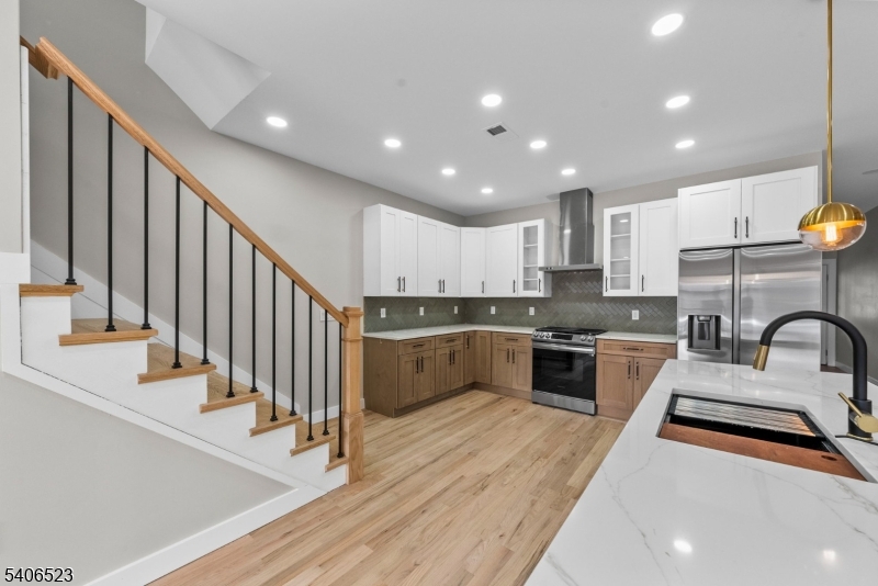404 Washington Street Perth Amboy, NJ 08861 - Photo 34 of 45 a kitchen with stainless steel appliances sink a stove and cabinets