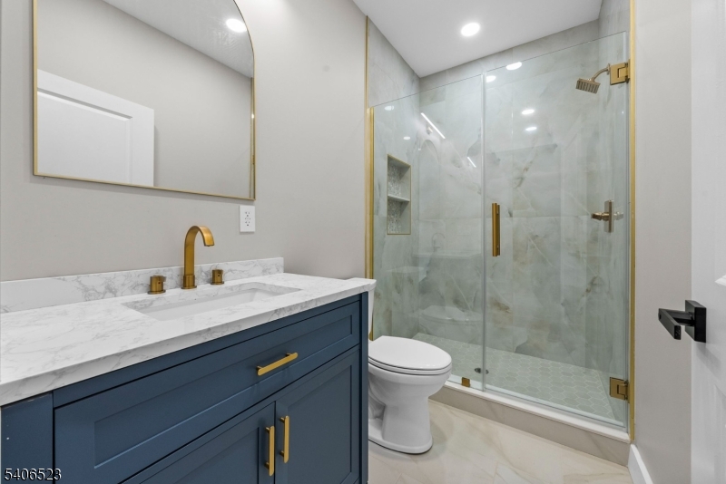 404 Washington Street Perth Amboy, NJ 08861 - Photo 35 of 45 a bathroom with a granite countertop sink a toilet and shower