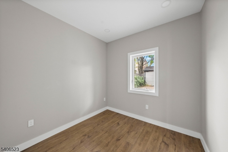 404 Washington Street Perth Amboy, NJ 08861 - Photo 36 of 45 an empty room with wooden floor and windows