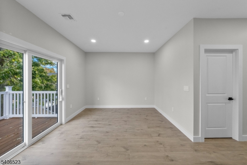 404 Washington Street Perth Amboy, NJ 08861 - Photo 8 of 45 an empty room with wooden floor and windows