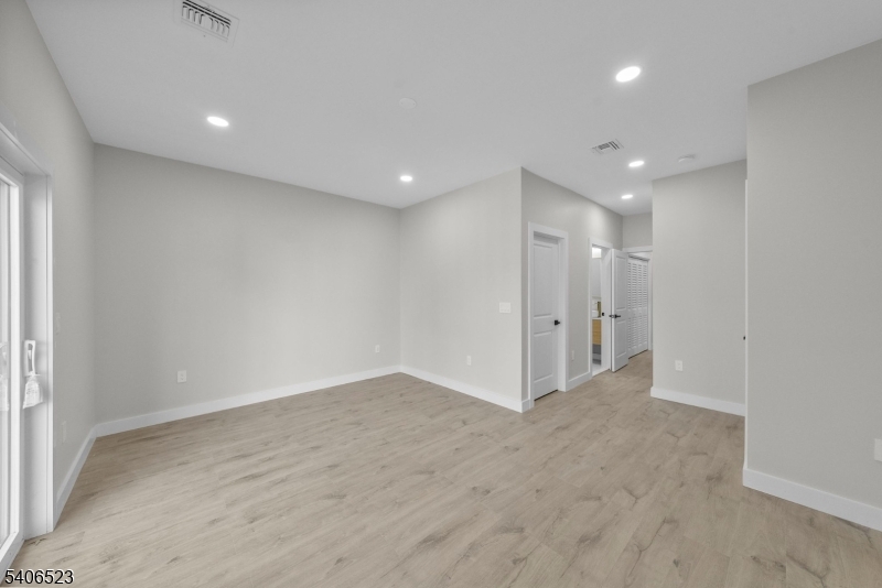 404 Washington Street Perth Amboy, NJ 08861 - Photo 9 of 45 an empty room with wooden floor and windows