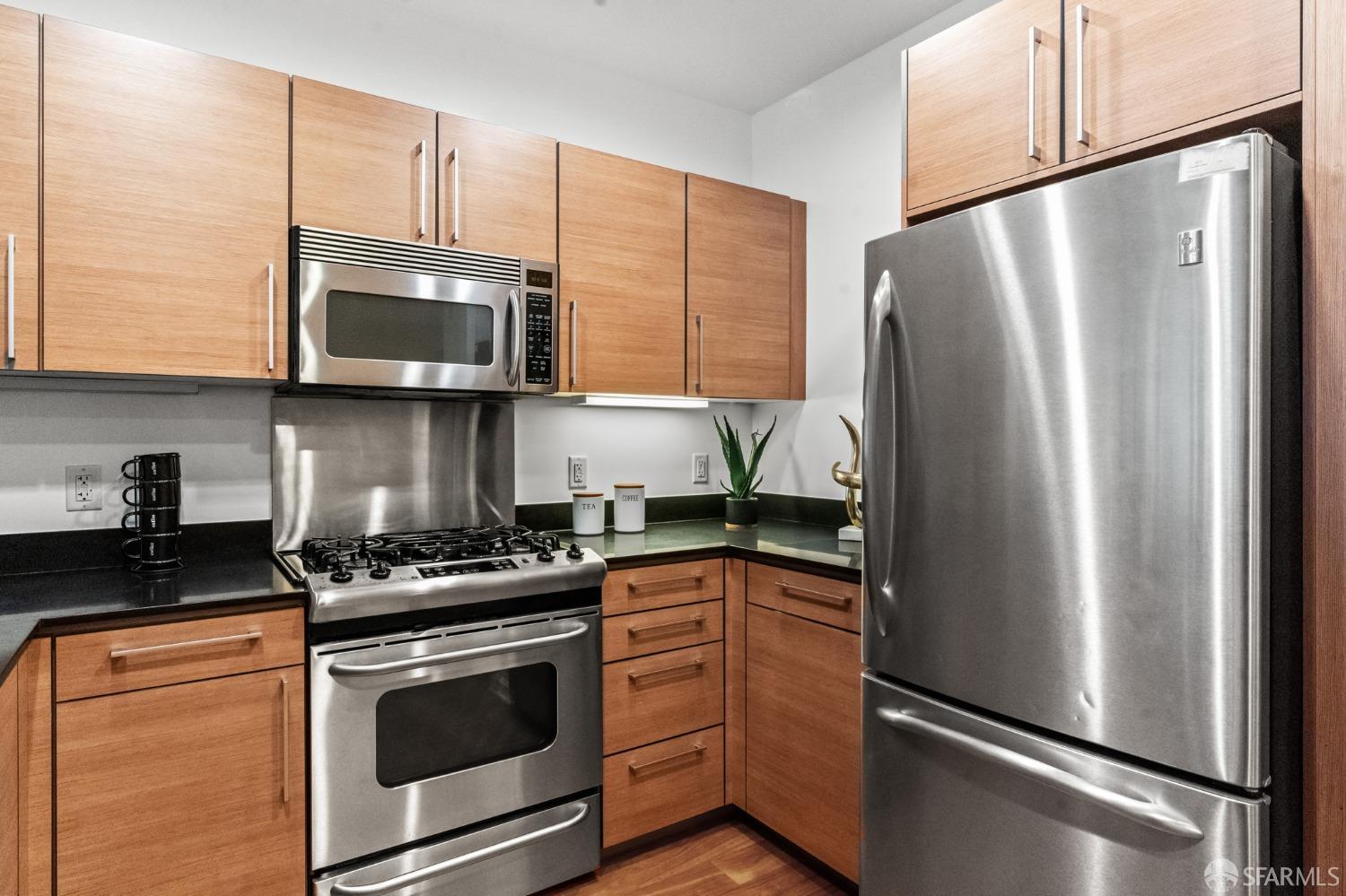 200 2nd Street, Unit 103 Oakland, CA 94607 - Photo 13 of 31 a kitchen with stainless steel appliances a refrigerator microwave and sink