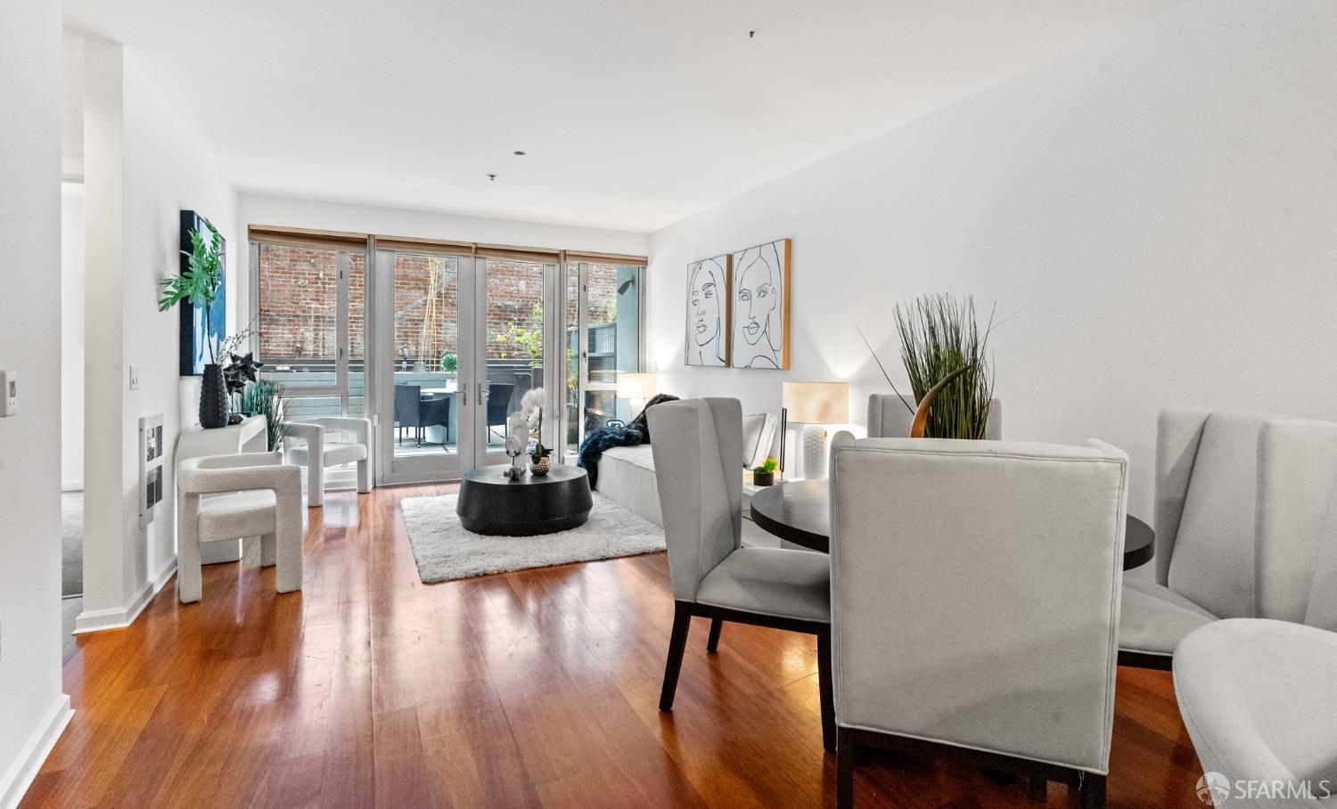 200 2nd Street, Unit 103 Oakland, CA 94607 - Photo 21 of 31 a living room with furniture wooden floor and a large window