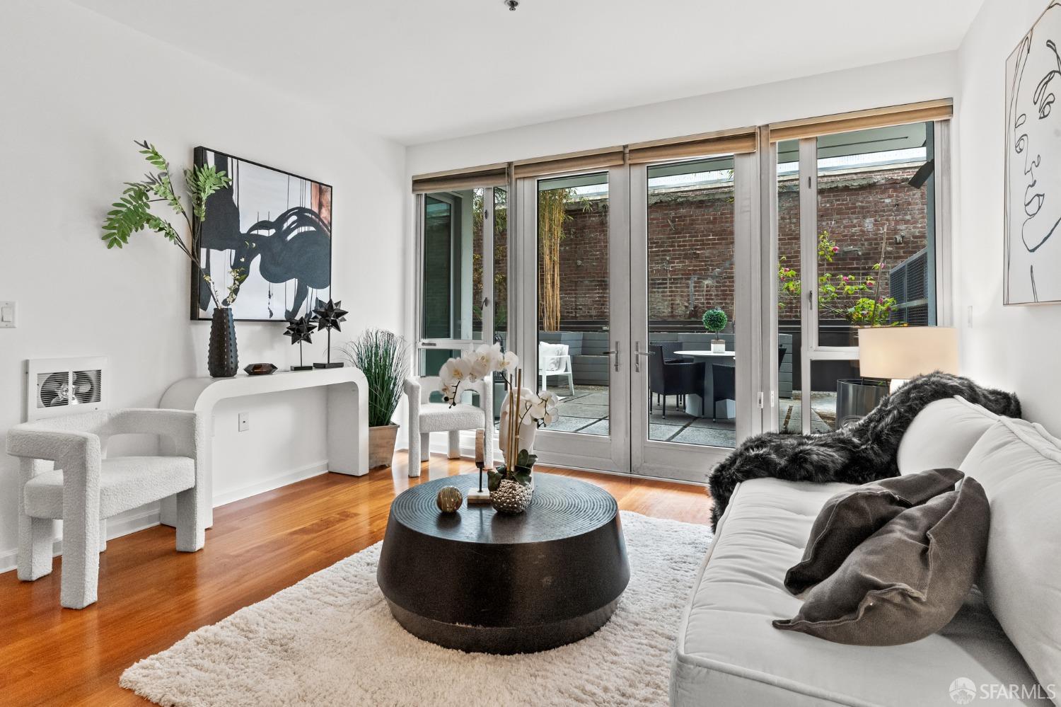 200 2nd Street, Unit 103 Oakland, CA 94607 - Photo 4 of 31 a living room with furniture and a large window