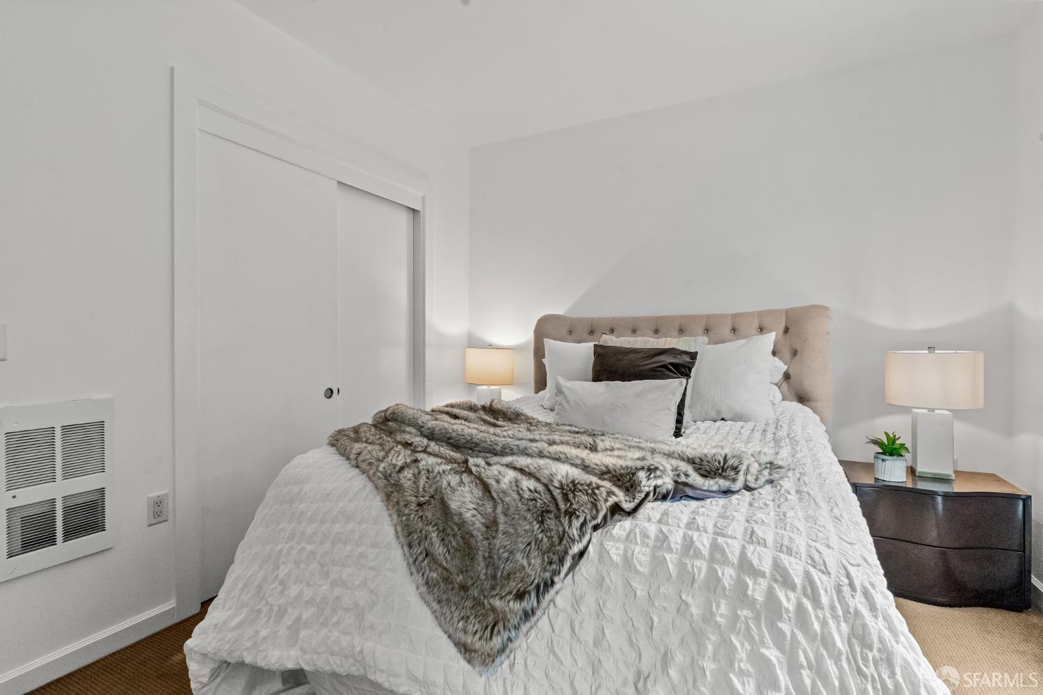 200 2nd Street, Unit 103 Oakland, CA 94607 - Photo 7 of 31 a bedroom with a bed and wooden floor