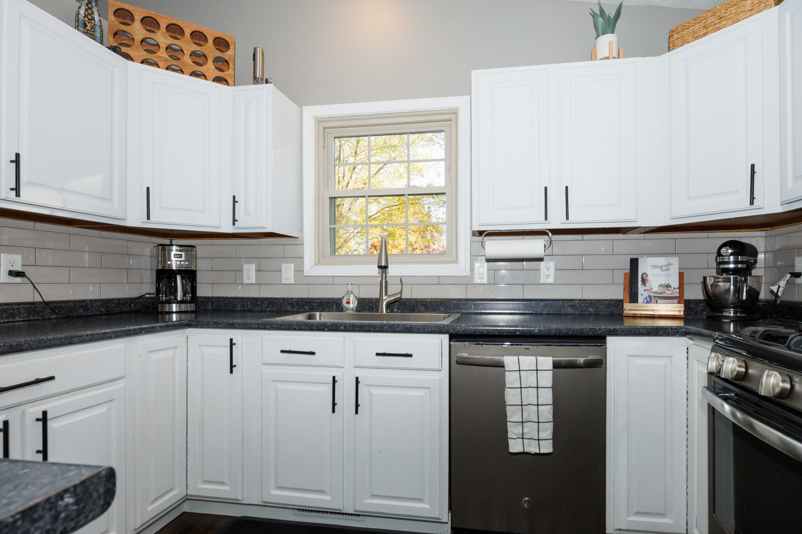 303 South Madison Street Towanda, IL 61776 - Photo 12 of 48 a kitchen with granite countertop white cabinets and white appliances