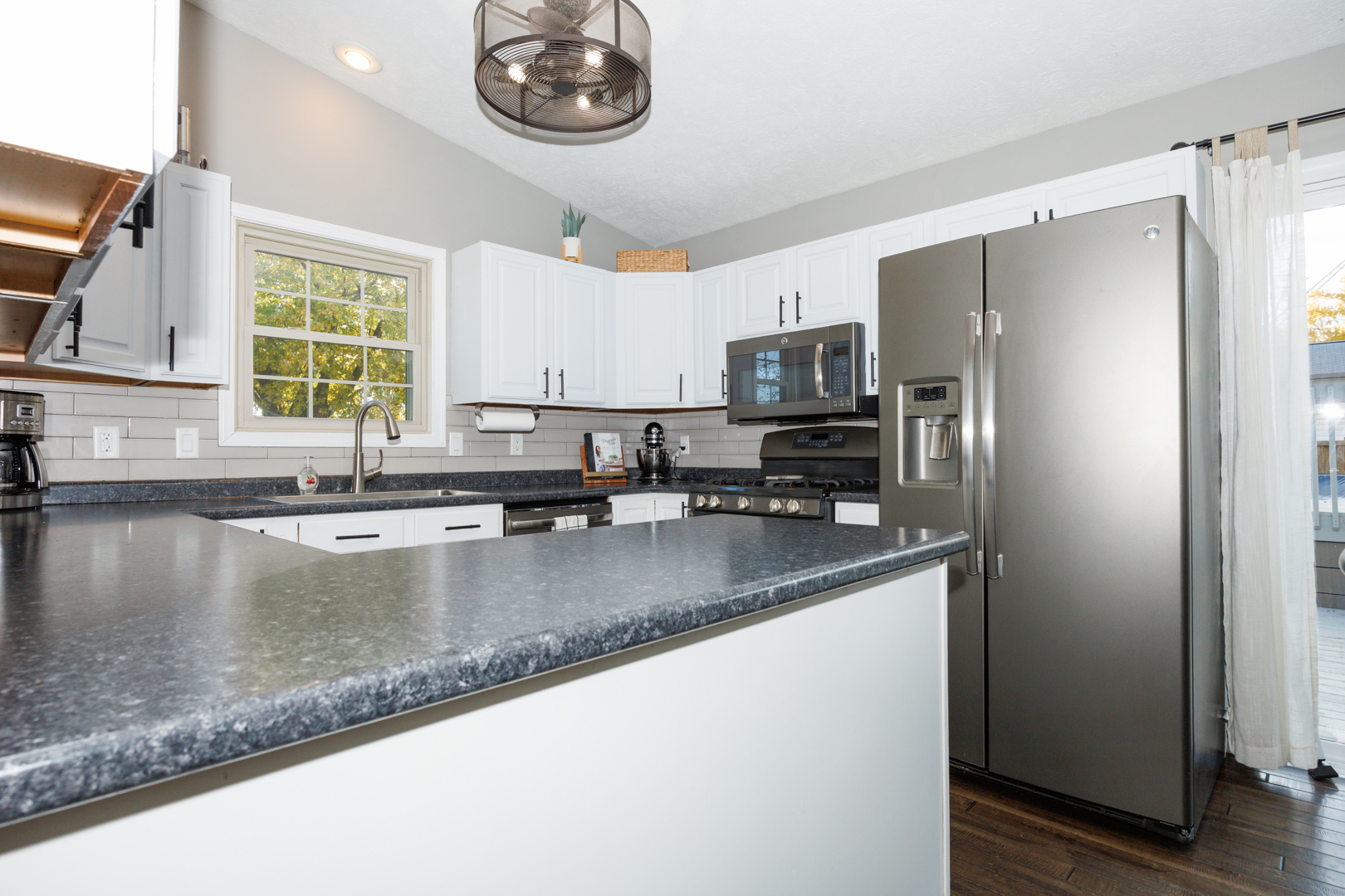 303 South Madison Street Towanda, IL 61776 - Photo 13 of 48 a kitchen with stainless steel appliances granite countertop a sink a refrigerator and a granite counter tops with a window