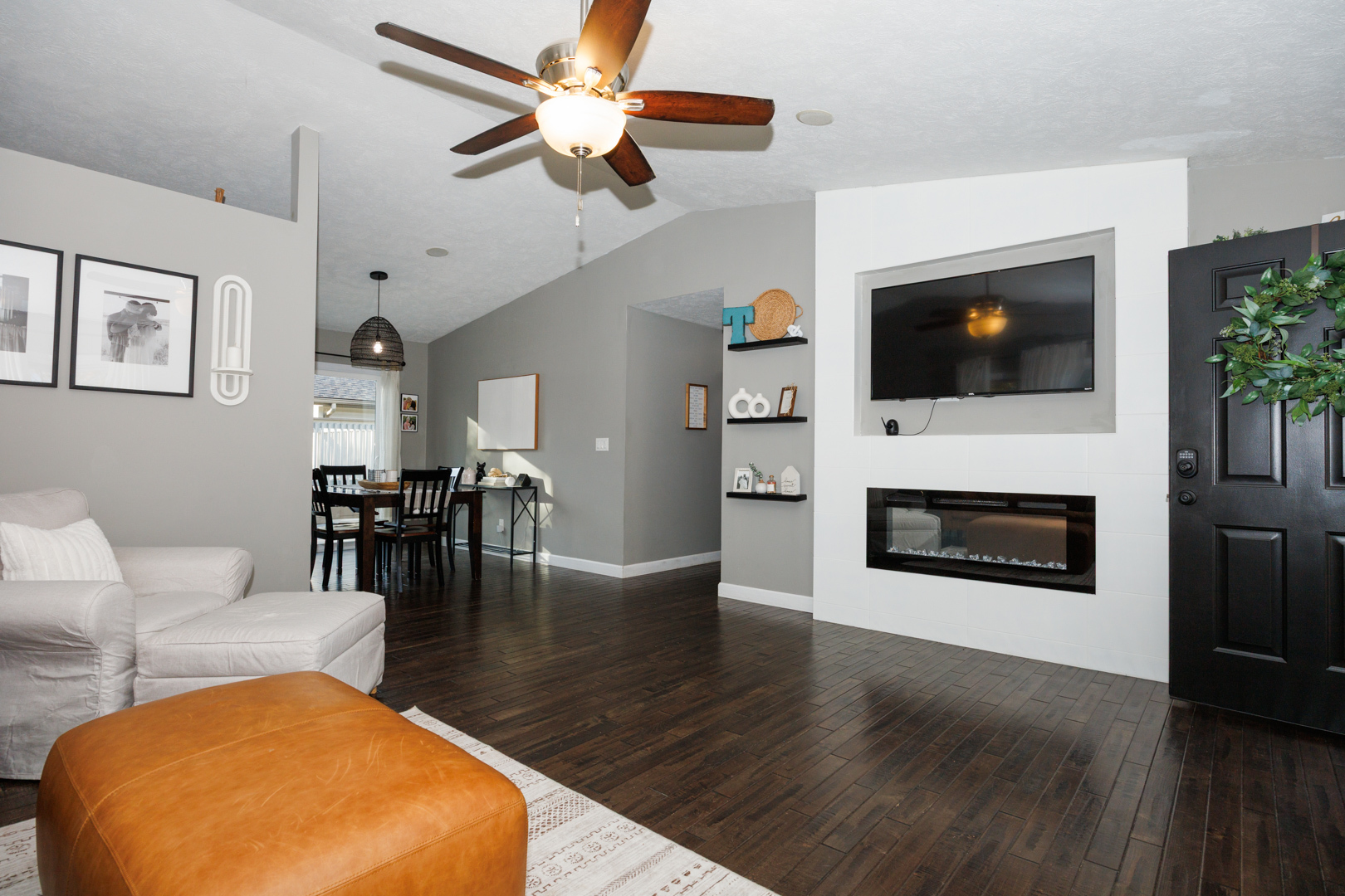 303 South Madison Street Towanda, IL 61776 - Photo 5 of 48 a living room with furniture a flat screen tv and a fireplace
