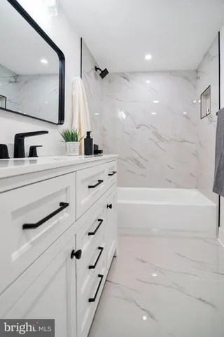 a bathroom with a bathtub and a sink