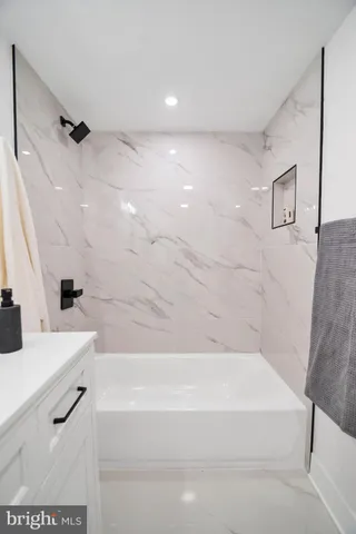 a bathroom with a bathtub and a sink