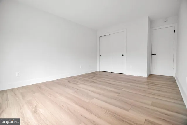 a bathroom with a granite countertop sink mirror vanity and toilet