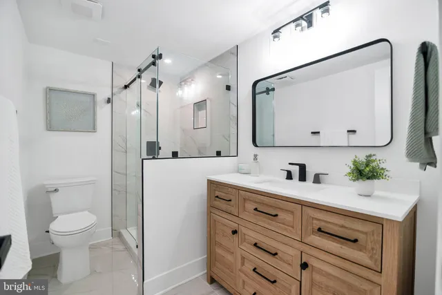 a bathroom with a toilet and a shower