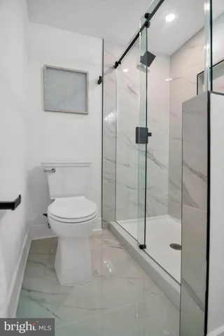 a bathroom with a sink vanity mirror and shower