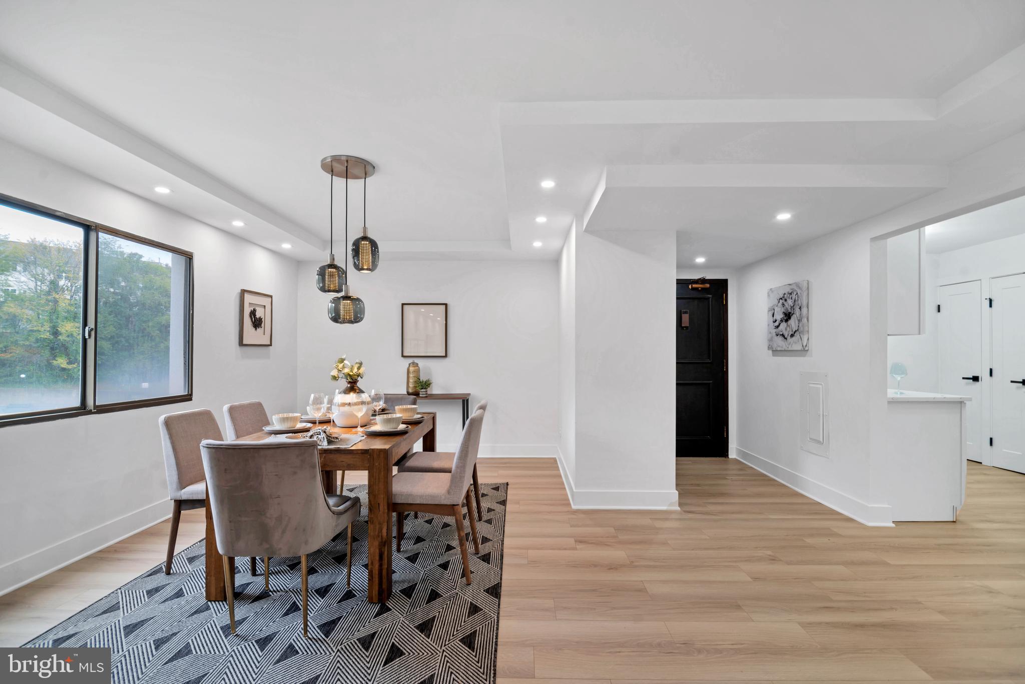 6101 Edsall Road, Unit 602 Alexandria, VA 22304 - Photo 4 of 31 a view of a dining room with furniture and wooden floor