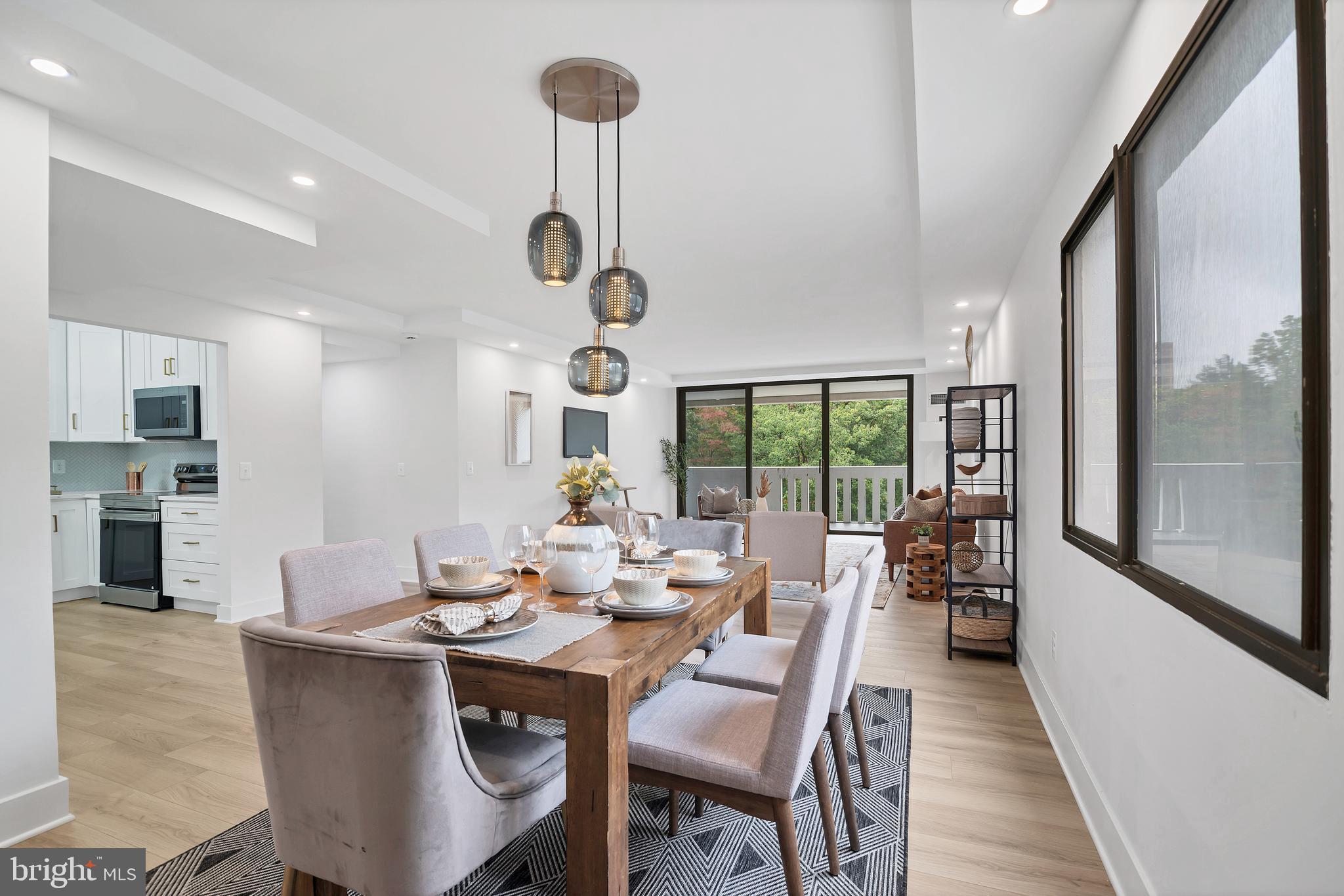 6101 Edsall Road, Unit 602 Alexandria, VA 22304 - Photo 5 of 31 a dining room with furniture a chandelier and wooden floor