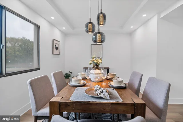 a view of a dining room with furniture wooden floor and chandelier