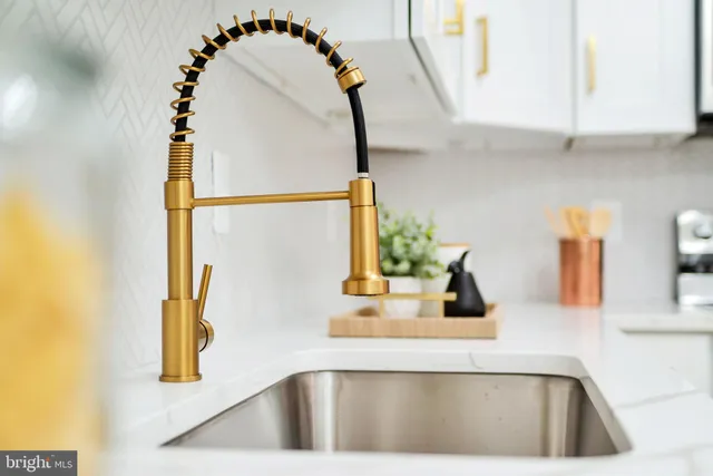 a kitchen with a sink and a mirror
