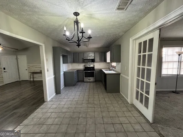 a large kitchen with stainless steel appliances granite countertop a refrigerator and a sink