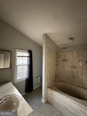 a bathroom with a bathtub and shower