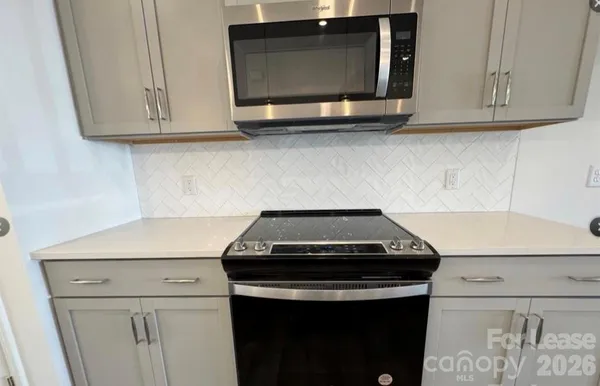 a view of a kitchen with a sink and a fireplace