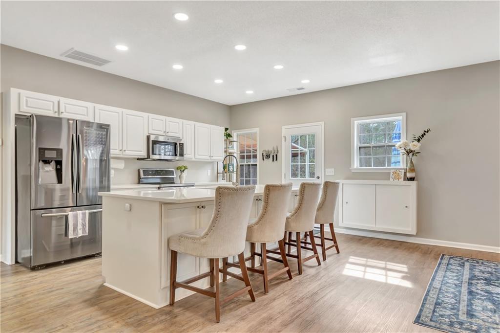 68 Skyview Road Senoia, GA 30276 - Photo 13 of 51 a kitchen with stainless steel appliances a refrigerator a stove a sink dishwasher with a dining table and chairs