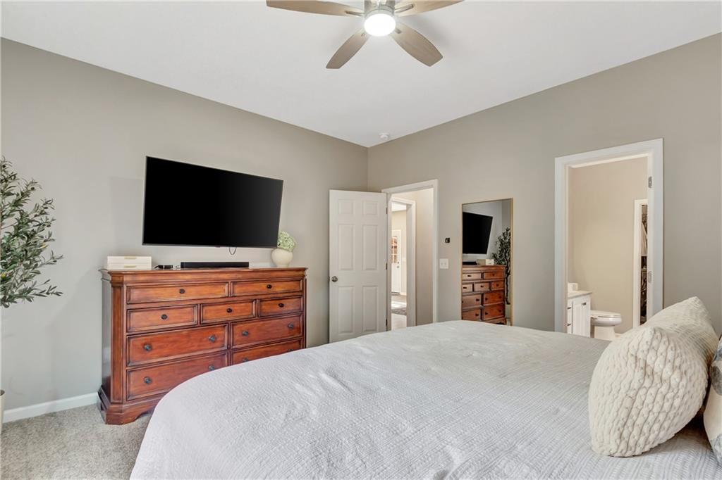 68 Skyview Road Senoia, GA 30276 - Photo 20 of 51 a bedroom with a bed and a flat screen tv in white dresser
