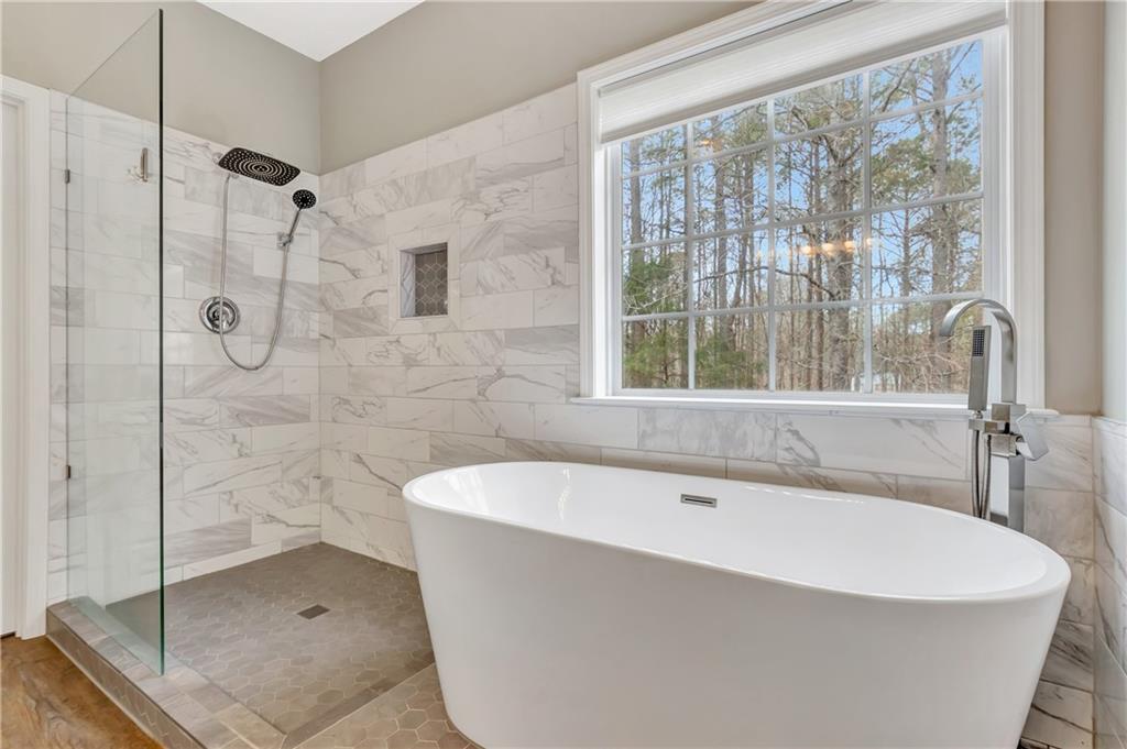 68 Skyview Road Senoia, GA 30276 - Photo 22 of 51 a white bath tub sitting next to a shower