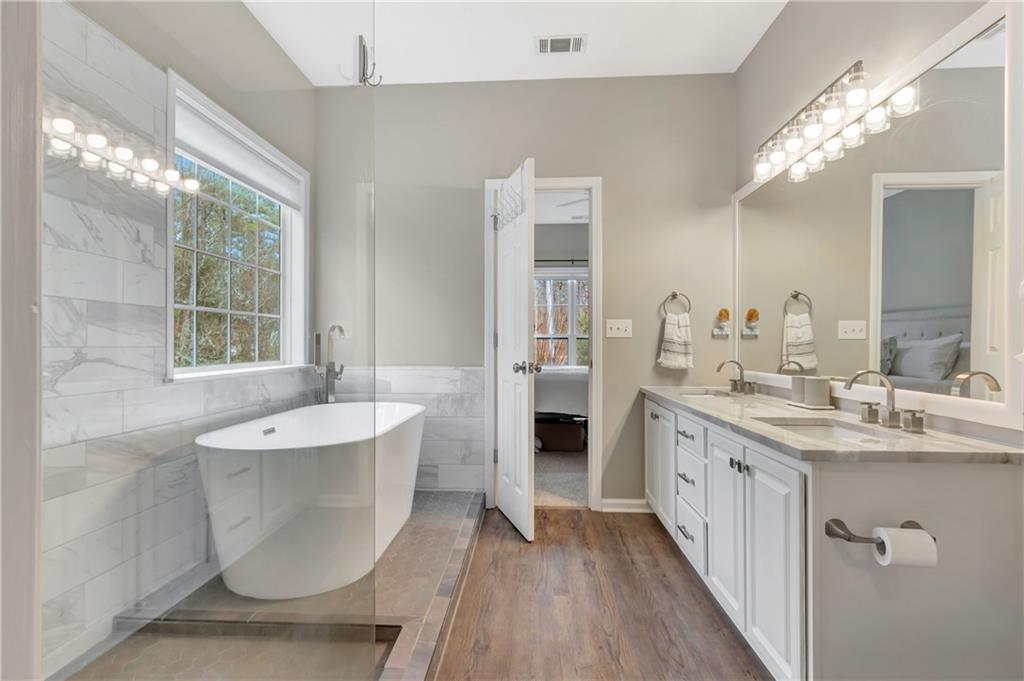 68 Skyview Road Senoia, GA 30276 - Photo 24 of 51 a en suite bathroom with a double vanity sink a mirror and a shower