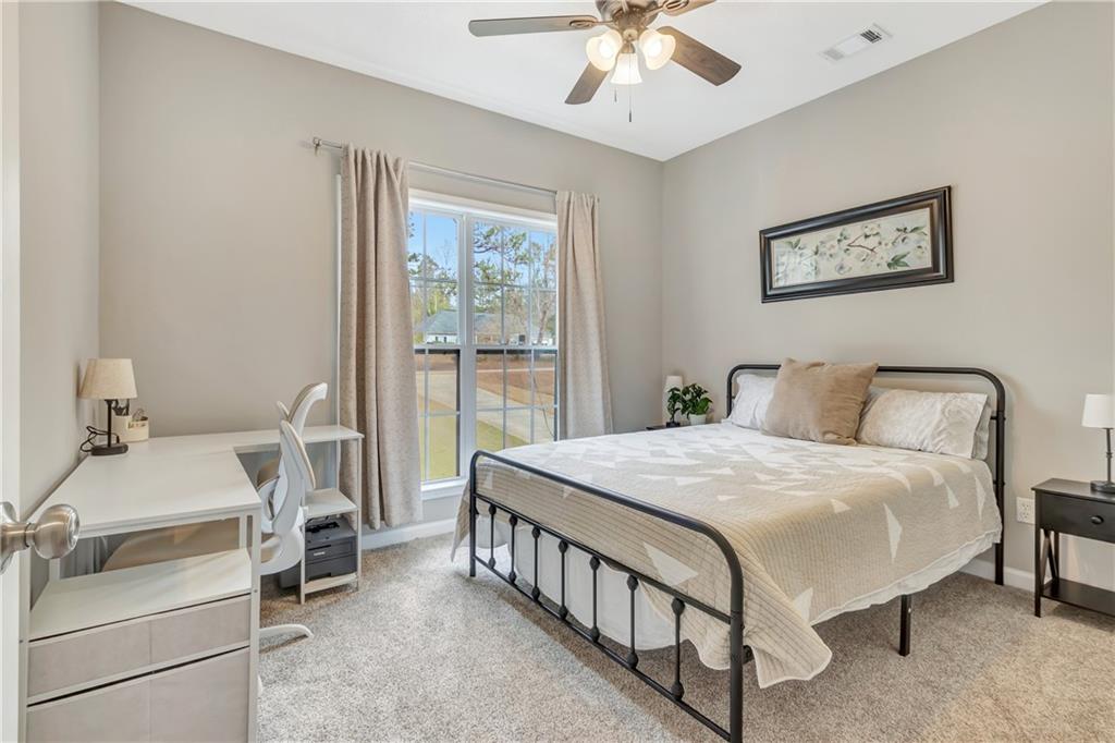 68 Skyview Road Senoia, GA 30276 - Photo 26 of 51 a bed room with a bed and a chandelier