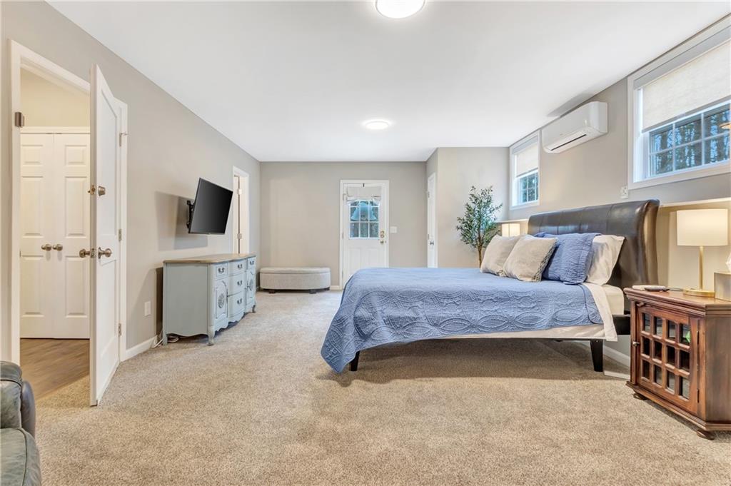 68 Skyview Road Senoia, GA 30276 - Photo 31 of 51 a spacious bedroom with a bed and a flat screen tv